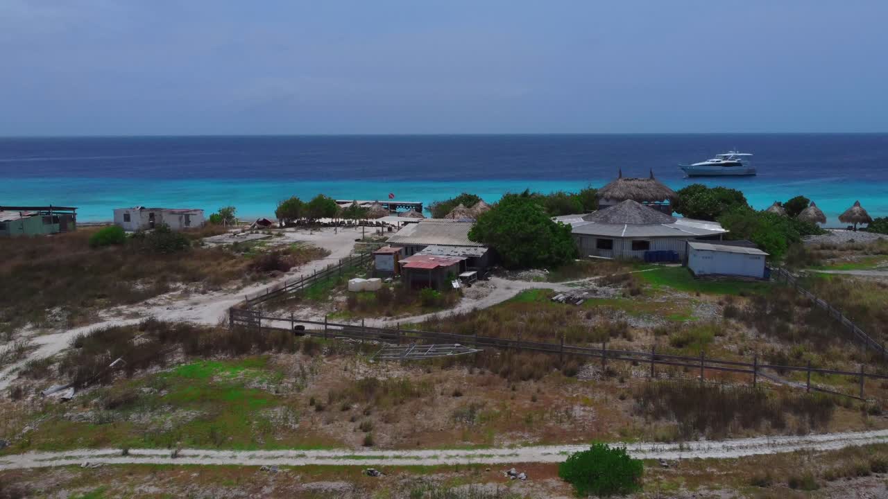 Flat Ground Reveal Waterfront Property with Picturesque Aerial of Yacht on Blue Water
