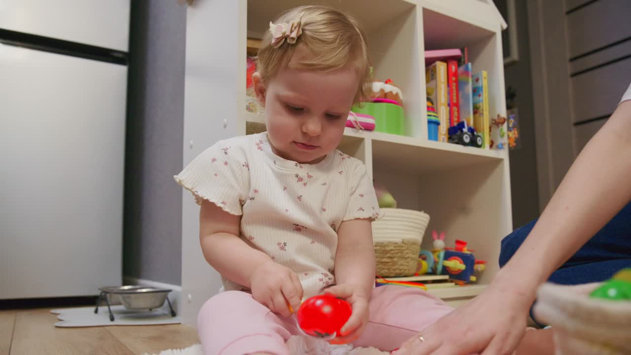 Little Girl Pretending to Cut Toy Tomato with Plastic Knife