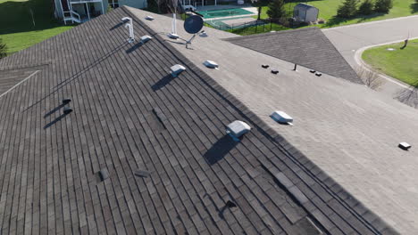 aerial, gray roof shingle tiles on a suburban home during the day