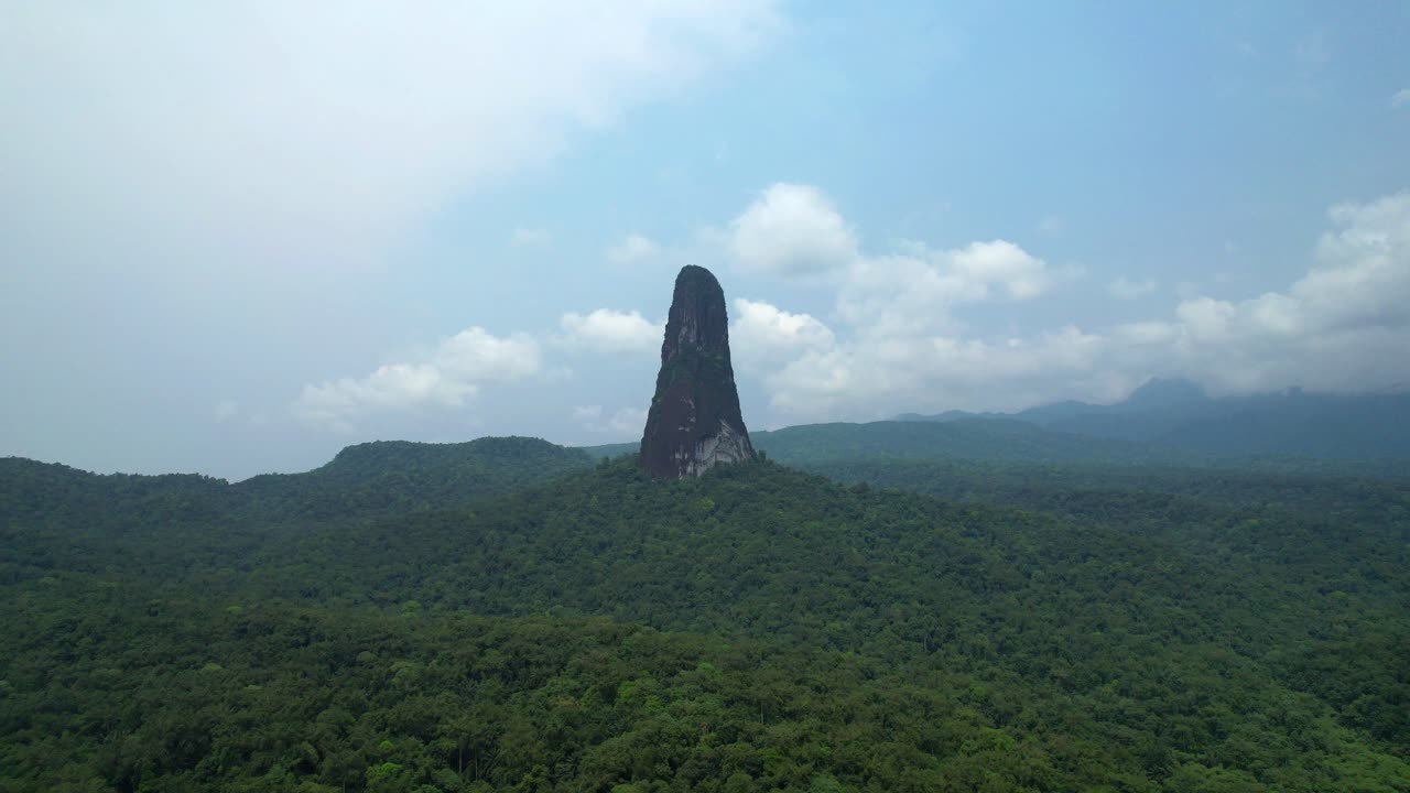 Aerial view of Pico Cao Grande mountain, in a sunny day Sao Tome - circular drone shot
