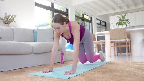 Mujer-Caucásica-Enfocada-Haciendo-Ejercicio-En-Casa-Sobre-Alfombra-En-Cámara-Lenta