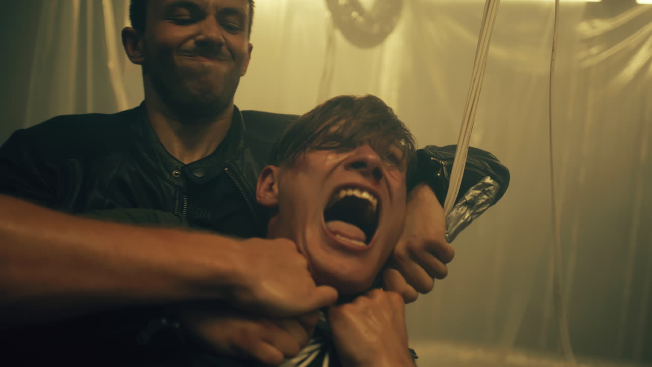 Male Killer Strangling Man with Wires