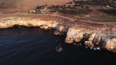 drone top down aerial view of waves splash against rocky seashore, background