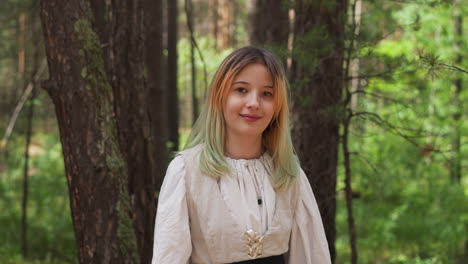 blonde girl smiles in medieval forest