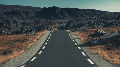 a narrow asphalt road leading through the outlandish northern landscape