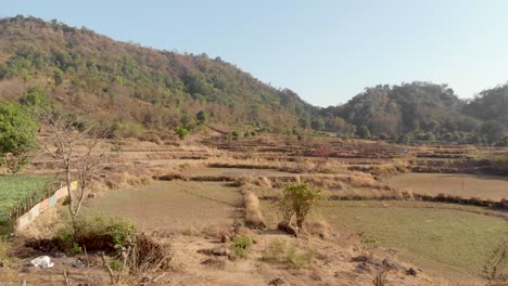 low drone shot of an indian hillside step farm