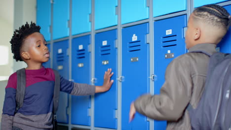 in school hallway, multiracial boys chatting by lockers, having friendly conversation