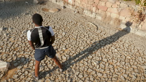 young black man stretching and warming up before running outdoors