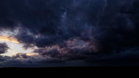 By-drone-over-a-stormy-sky-with-dark-and-threatening-clouds,-illuminated-by-lightning,-giving-the-impression-of-a-coming-storm,-offering-an-intense-and-striking-aerial-view-of-the-storms