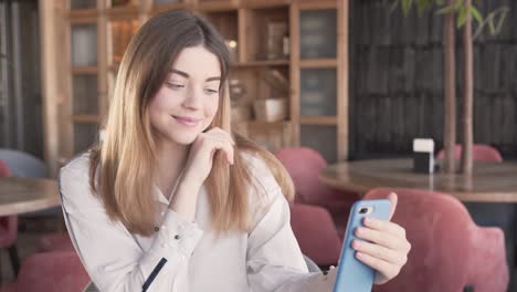 a sweet young girl does a video call via her phone