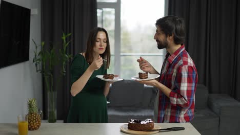 Handsome-husband-and-his-beloved-pregnant-wife-eating-tasty-dessert