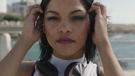 close-up-portrait-of-young-hispanic-woman-looking-confident-running-hands-through-hair