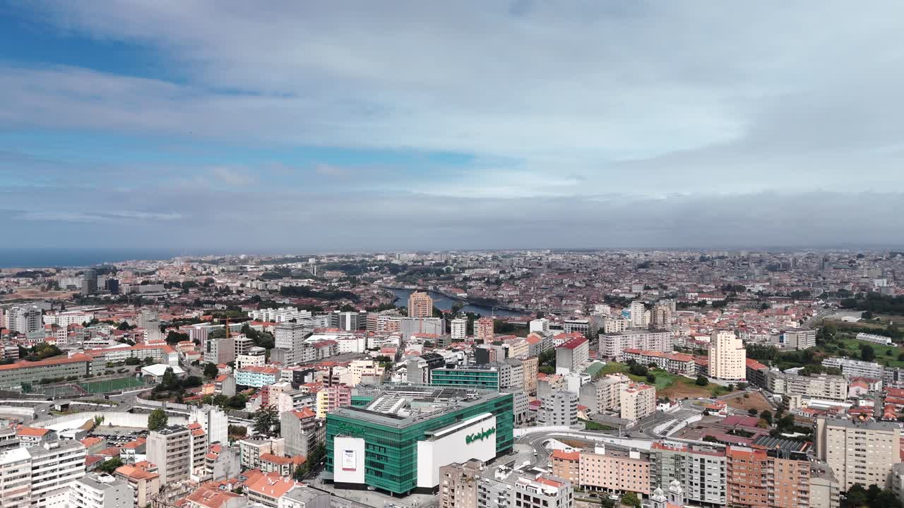 Aerial view of the Vila Nova de Gaia city center with dense buildings under a cloudy sky, Portugal