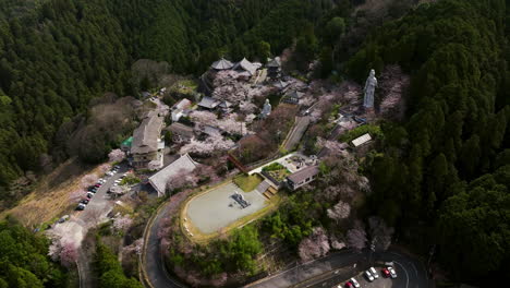 Tsubosaka-dera-Temples-With-Pagoda,-Statues-And-Cherry-Blossoms-Near-Nara-In-Japan