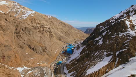 flyover establishing checkpoints at the entrance of a copper mine in the mountains on a sunny day, chile