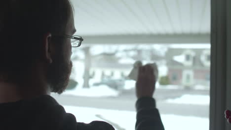 man cleaning glass on storm door tilt up slow motion