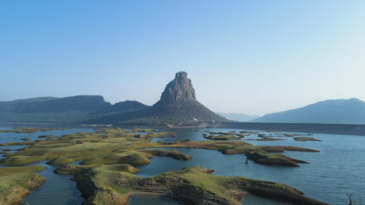 Aerial shot of the reservoir at Karamchat Dam, with the dam wall stretching across the river.