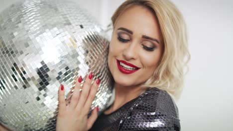 Female-model-with-disco-ball-posing-in-studio-shot