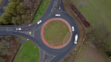 over head drone shot of a roundabout being used by cars and lorries in england