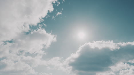 clouds move on pale blue winter sky on sunny day, timelapse