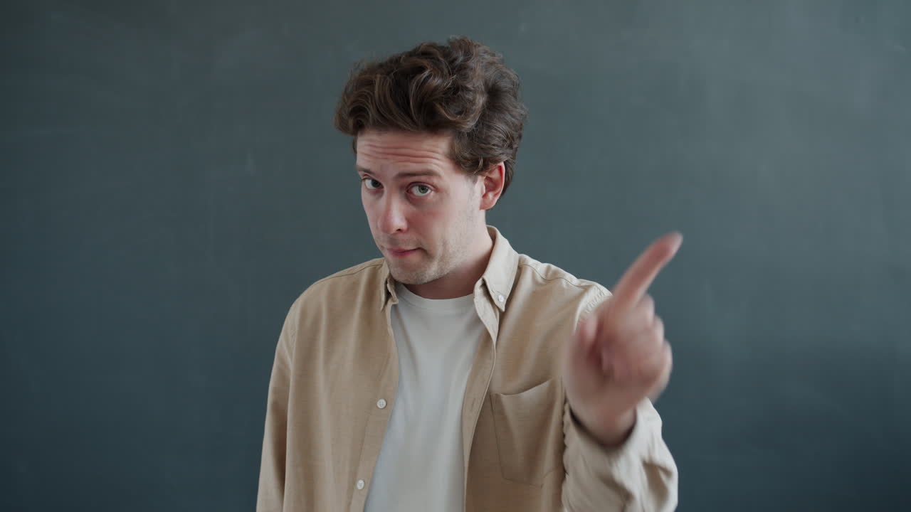 Man Pointing with Disapproving Gesture