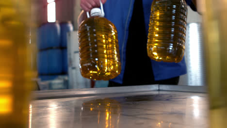 olive oil can being kept on table in oil factory