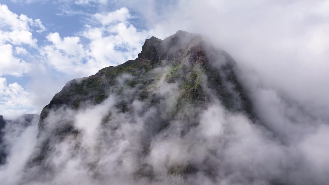 Mysterious drone view of low cloud fog around mountains at Curral das Freiras