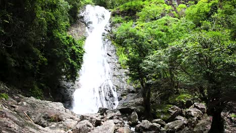 Namtok-Sarika-Waterfall-in-Nakhon-Nayok,-Thailand-in-dense-foilage-and-surround-trees-with-rocks
