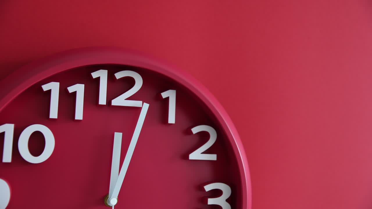 Time lapse of red wall clock on red background