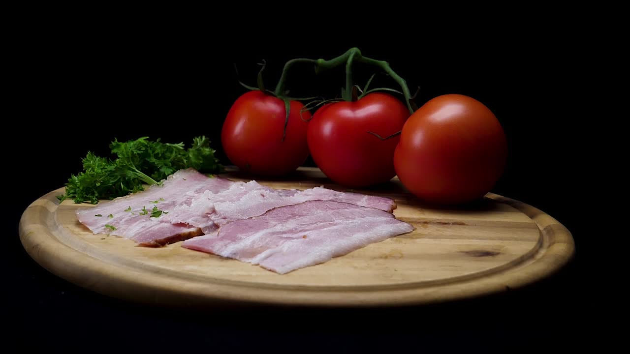 Sliced Bacon with Tomatoes on Wooden Board