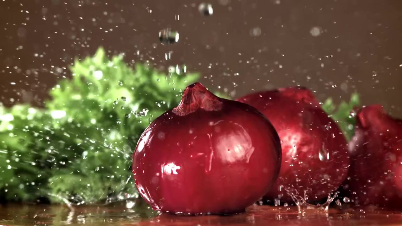 Slow Motion Water Splashing on Fresh Red Onions