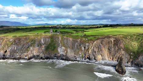 ireland epic locations dramatic light as shadows move over the sea cliffs at copper coast waterford ireland