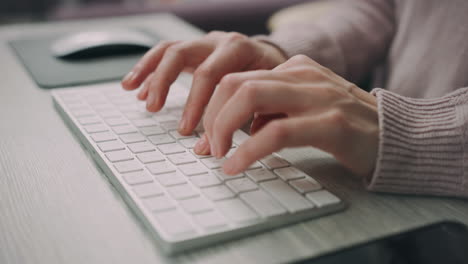 female hands typing on modern keyboard. freelance worker typing keyboard