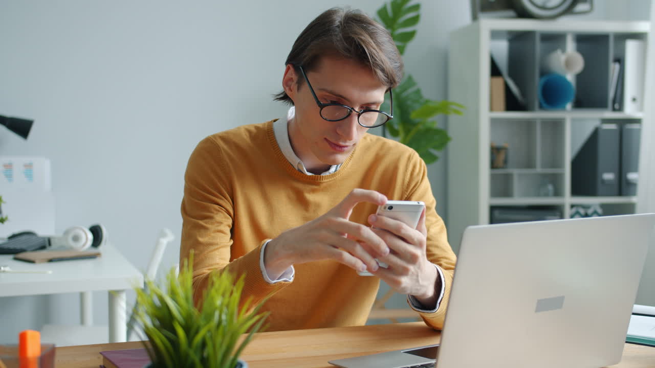 Man using mobile phone in office