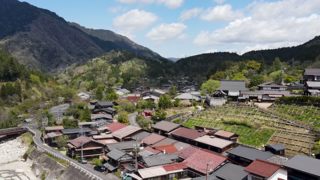Aerial View Over Rooftops Of Tsumago-Juku Town In Nagano Prefecture. Dolly Back With Valley View In The Background