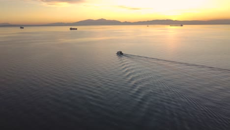 Thessaloniki,-Θεσσαλονίκη,-Saloniki,-Small-Boat-Sailing-off-into-the-Sunset,-Fishermen,-Thessaloniki-Greece,-Boat,-Travell,-Discover,-Motivation,-Explore,-Seaguls,-Over-the-Horizon,-Orange,-Colourful