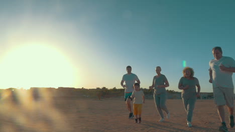 Family-run-on-the-beach-at-sunset