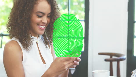 Animation-of-fingerprint-over-biracial-woman-using-smartphone