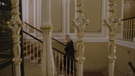 people walking up grand hotel stairs