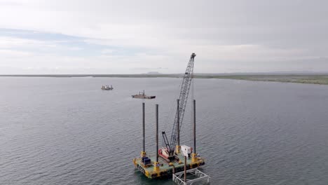 aerial view passing a offshore natural gas pumping station on the caribbean sea