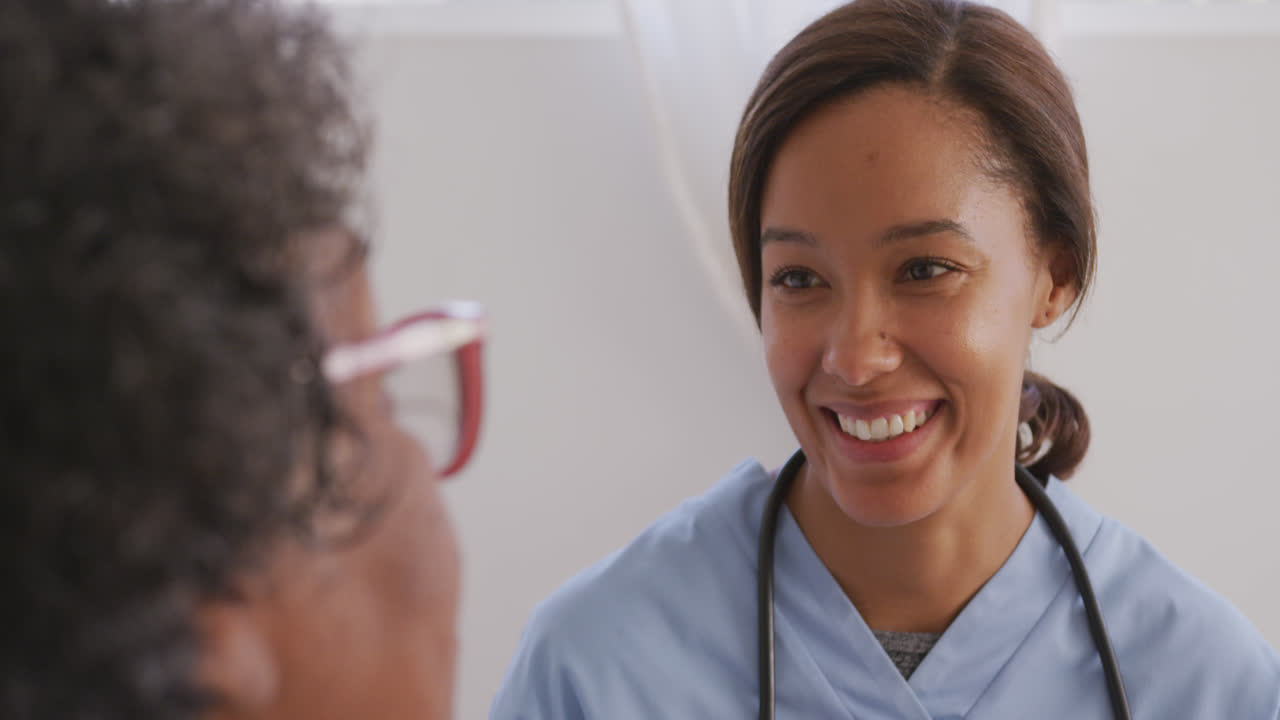 Mixed race woman being visited at home by a nurse. Social distancing and self isolation in quarantin