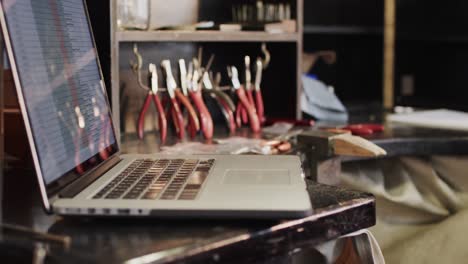 Close-up-of-laptop-and-handcraft-tools-in-studio-in-slow-motion