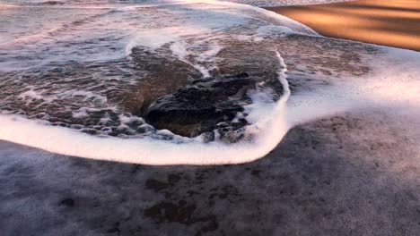 ocean waves crashing on a lone rock