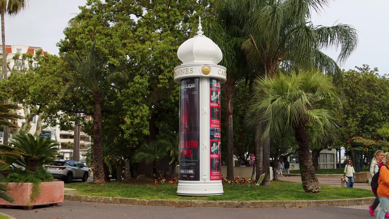 Advertising Column With Cannes Sign And Movie Posters In France. wide shot