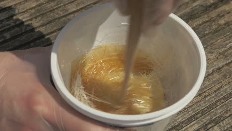 mixing chopped strand fiberglass with polyester resin