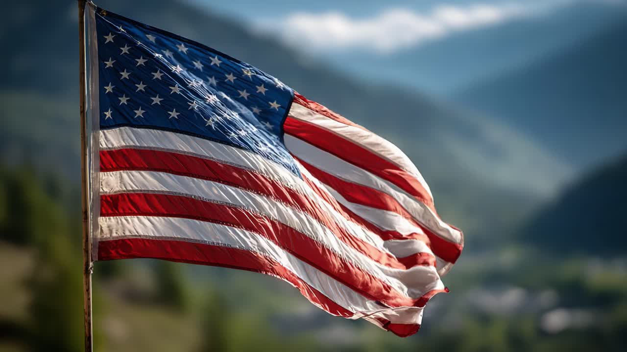 Majestic Display of National Pride: A Beautiful American Flag Waving in the Breeze Against a Scenic Mountain Background at Dawn