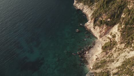 aerial drone video of iconic geological phenomenon of blue caves in northern zakynthos island with deep sapphire rocky seascape