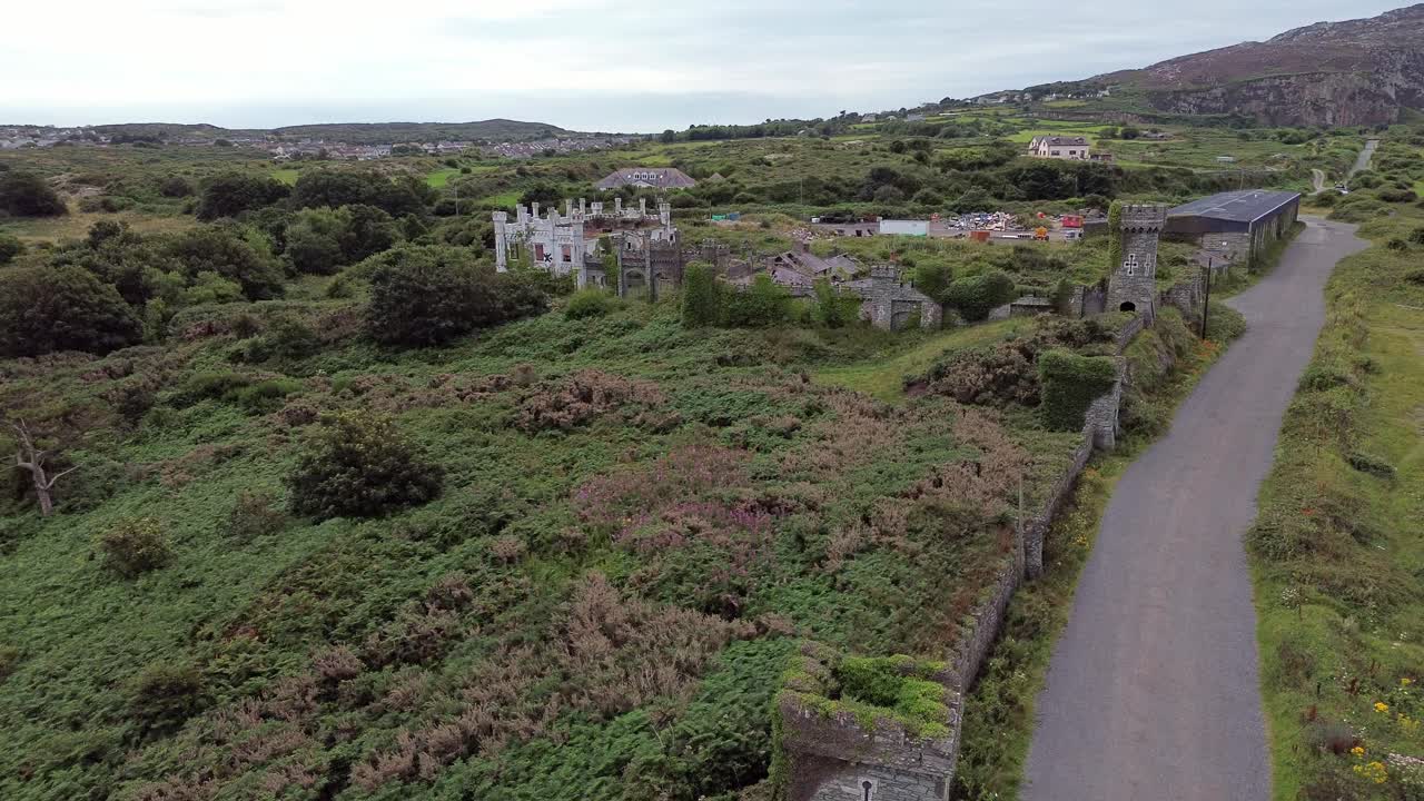 Drone clip showing castle ruins of the abandoned Soldiers Point hotel, Holyhead, North Wales, UK
