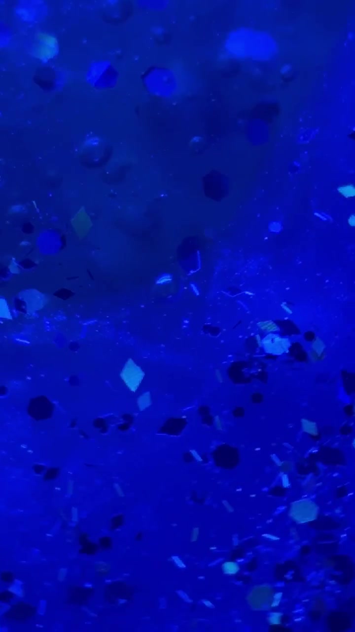 Particelle di glitter astratte in liquidi vibranti.