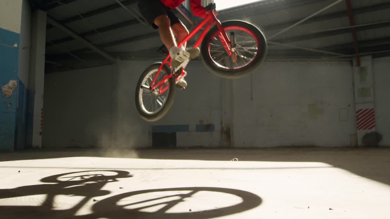BMX rider in an empty warehouse